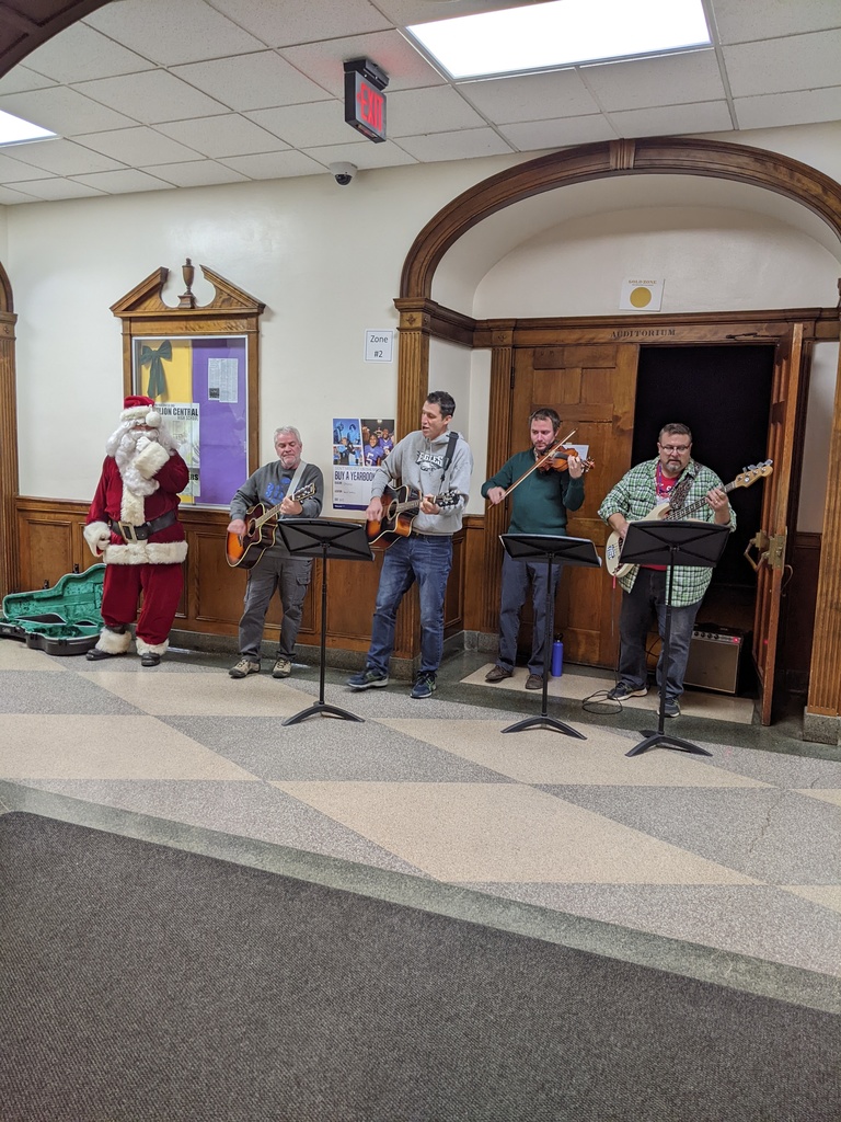 faculty and Santa singing Christmas carols