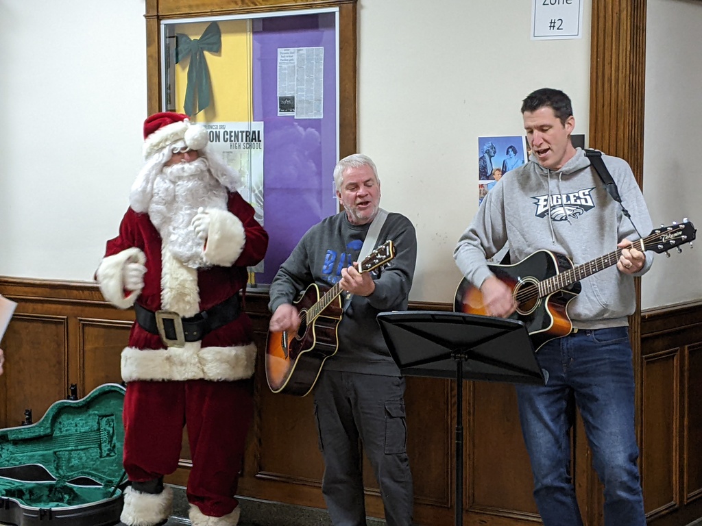 teachers and santa playing instruments and singing