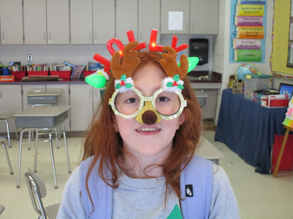 student with holiday glasses and headband