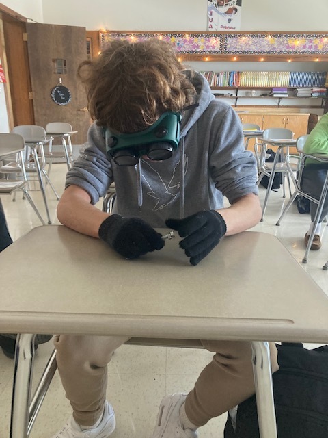 student with alcohol simulation goggles