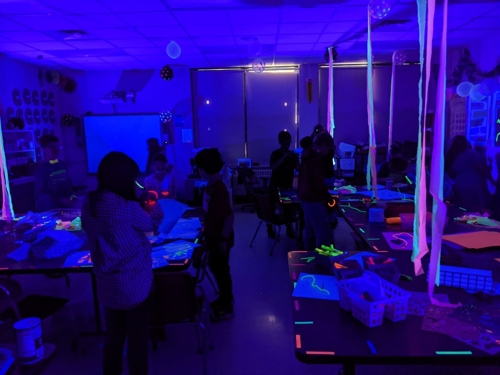 students in a room with black light